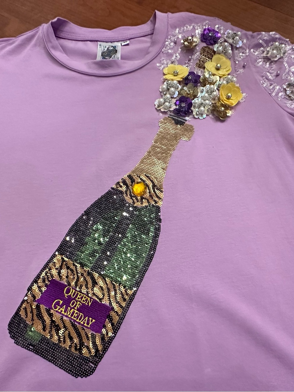 Queen of Sparkles Popping Champagne Tee with Tiger Stripe Detail. Size M